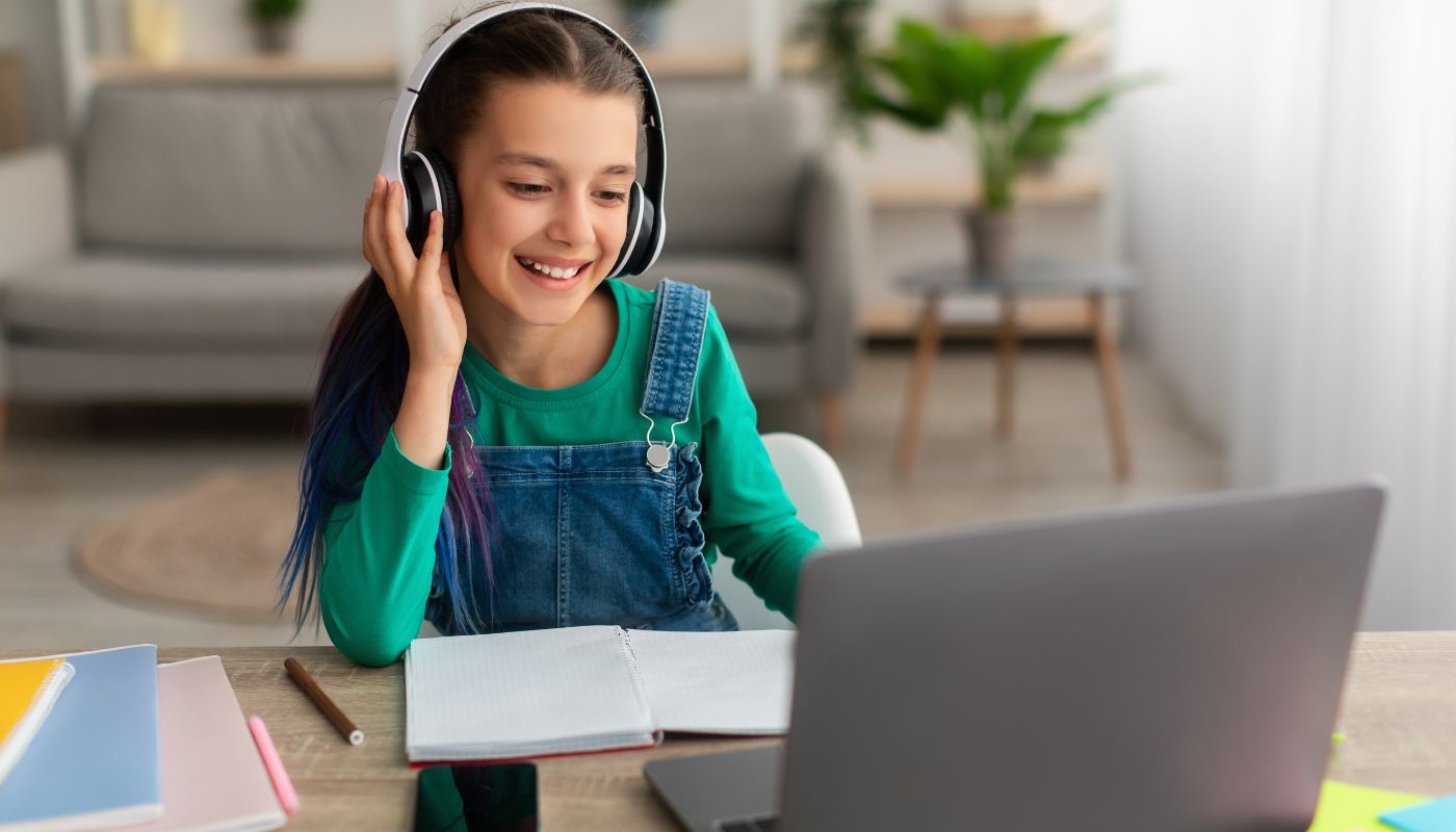 A child using laptop and smiling 